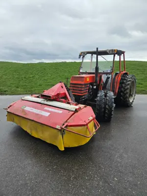 Polytrac 50 mit Frontmähwerk und Heckschaufel